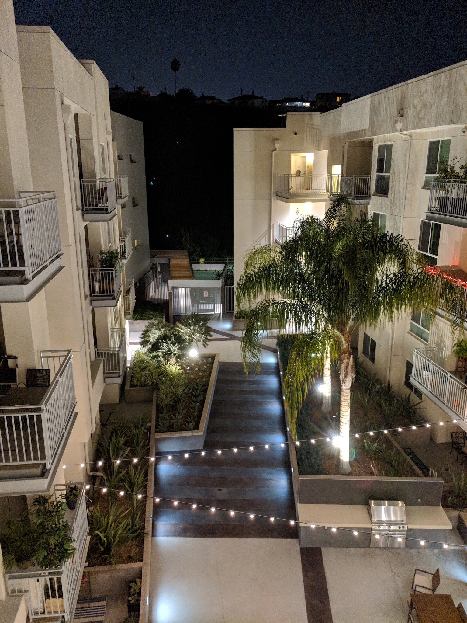 Outside at night just outside front door - Gas grill community space - 12655 Bluff Creek Dr