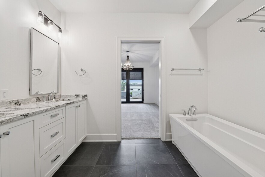 Private primary bath with heated tiled floors, double vanity areas, and great cabinet space. - 222 Ferndale Rd S