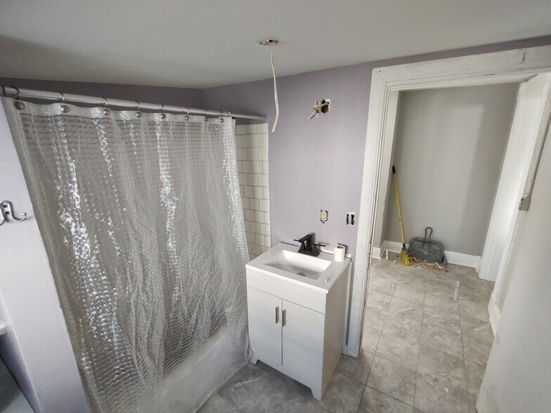 Bath: New sink, light fixtures, shelving, mirror. - 208 E 9th St