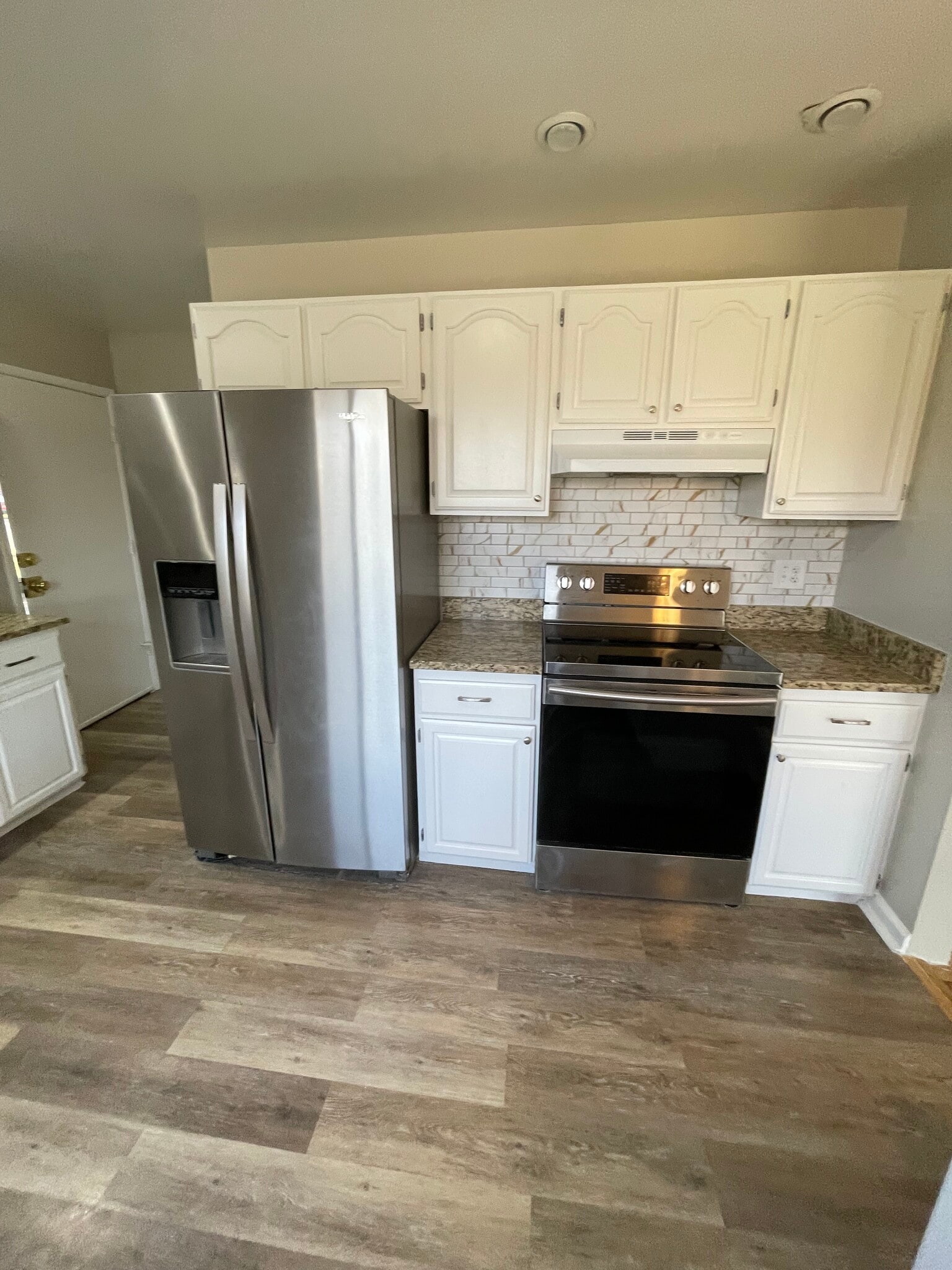 Remodeled kitchen with stainless steel appliances and granite countertops - 7991 E Hampden Cir