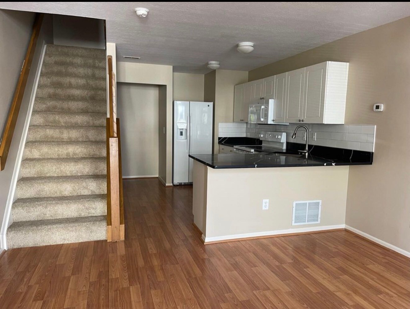 Open main living space with updated flooring and modern kitchen layout. - 289 Preswicke Ml