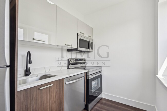 Building Photo - Sleek, Bright & Brand New — Stylish Studio...