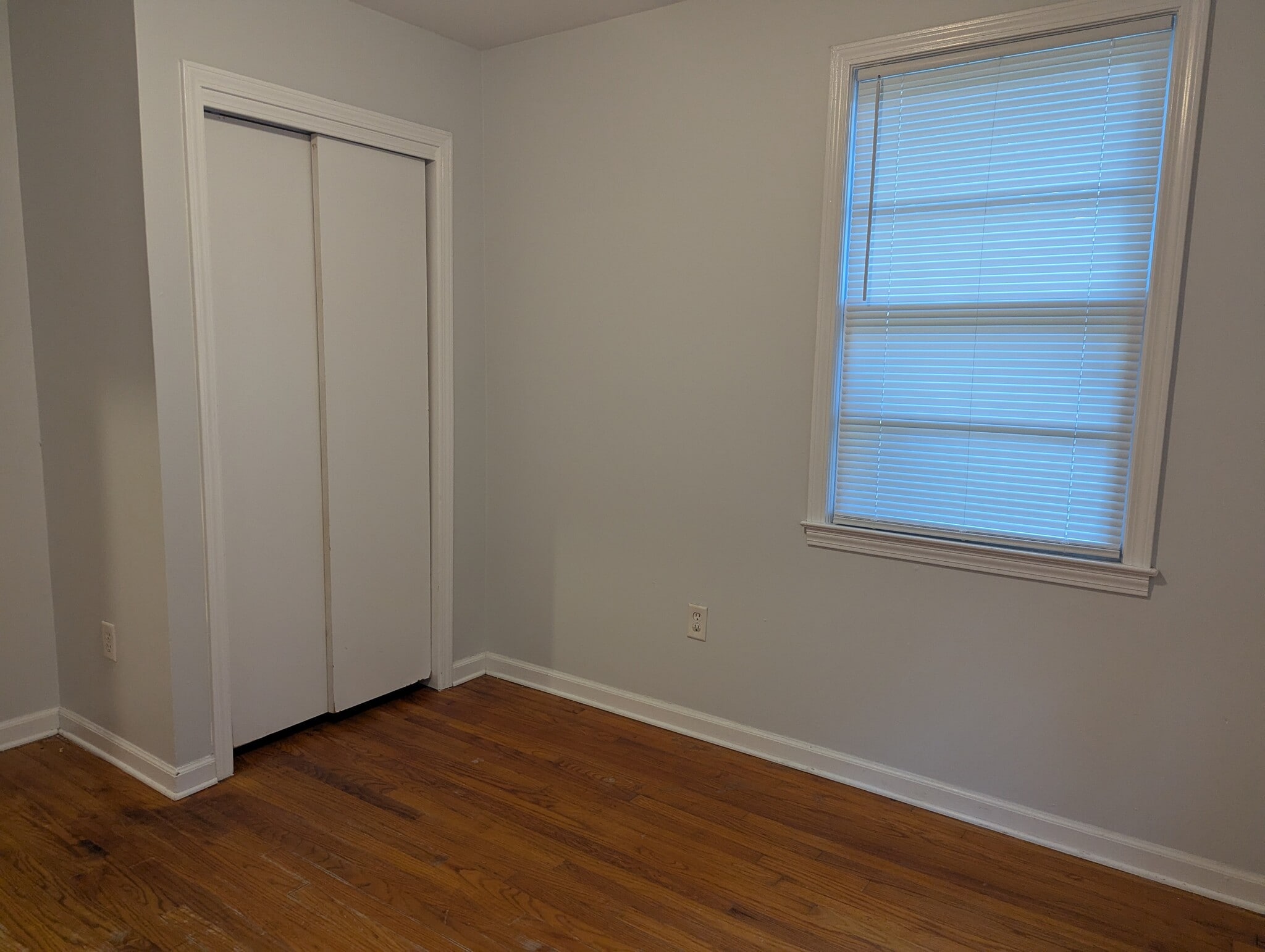 Bedroom corner highlighting closet storage and natural window light. - 1527 Brookbank Ave