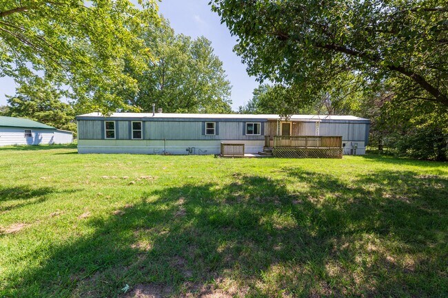 Primary Photo - Updated mobile home on acre lot with garag...