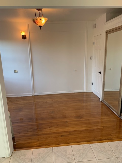 Bedroom with hardwood floors and mirror closet doors - 365 Beloit Ave