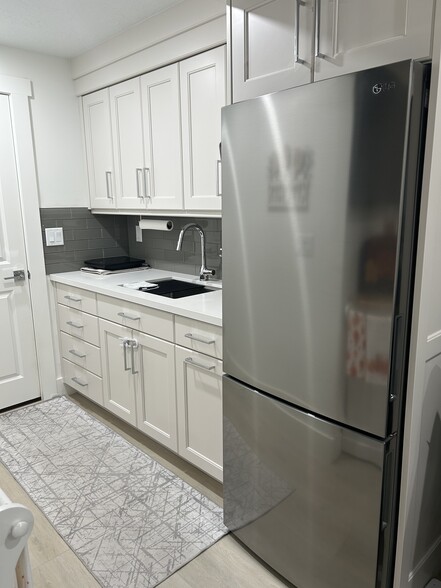 Kitchenette area with full size sink and medium sized fridge. Burner available for use. - 11452 S Marco Polo Ln