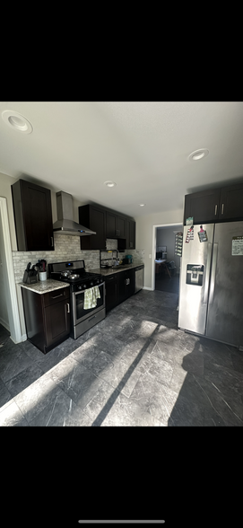 Kitchen, gas range stove, fridge, dishwasher, disposal. Living Space B & C off kitchen. - 1865 Winthrop Dr SE