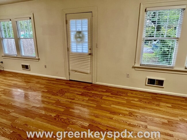 Building Photo - This 3-bedroom 1-bathroom house has a large front yard and a mostly fenced backyard.