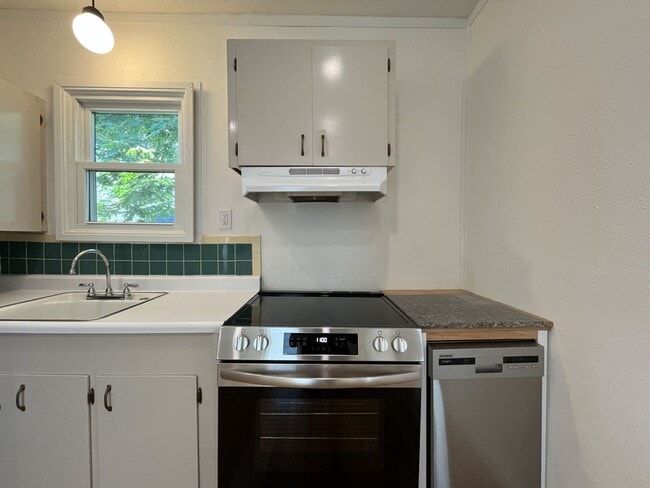 Building Photo - Charming Cottage with Hardwood Flooring, Modern Kitchen & Beautiful Outdoor Living Areas