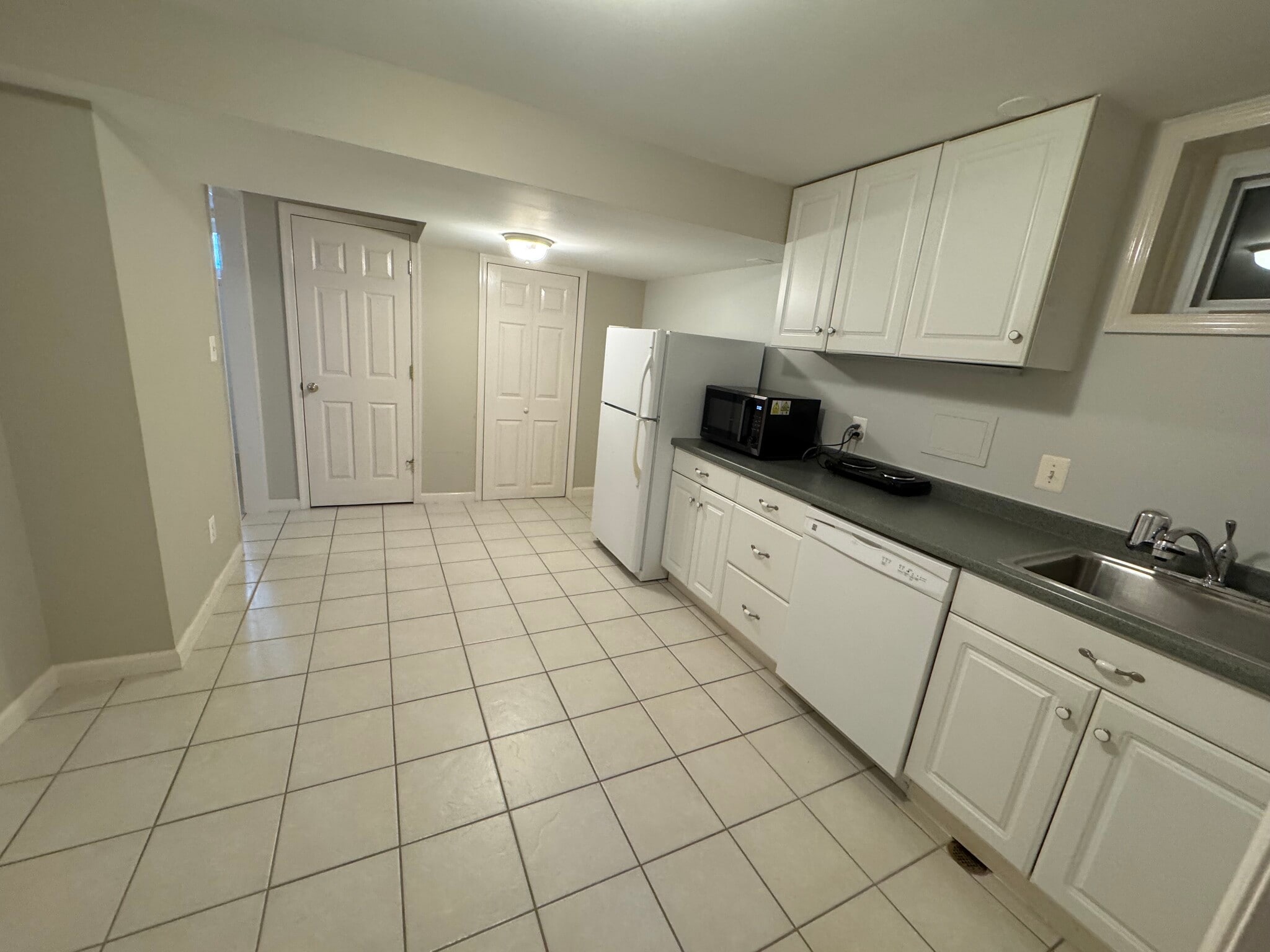 Kitchen, with tiled floor and in-unit washer/dryer - 201 E Indian Spring Dr