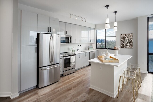 Stunning kitchens include contemporary European-style cabinets and designer pendant lighting. - Centrico by Windsor