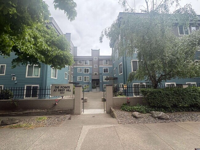 Building Photo - Bright, Modern 1BR Near Hospitals, SU & Transit in secure building with garage parking and a Walk...