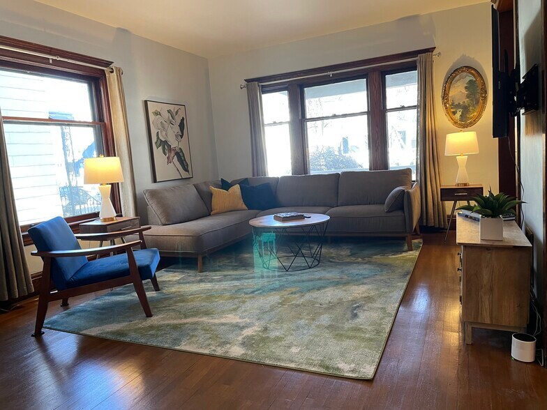Living room looking out to the large front porch. - 28 Saint James Pl
