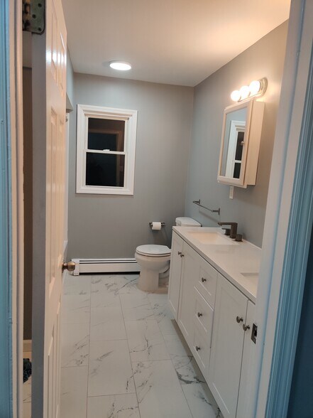 Renovated second bathroom with double sink vanity - 186 Highland Ave