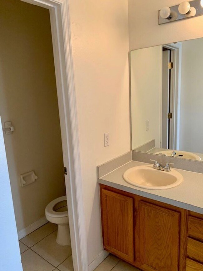 Building Photo - Available NOW! NEW FLOORS AND PAINT! Lovely 3/2 in Poinciana! HUGE fenced yard and NO CARPET!