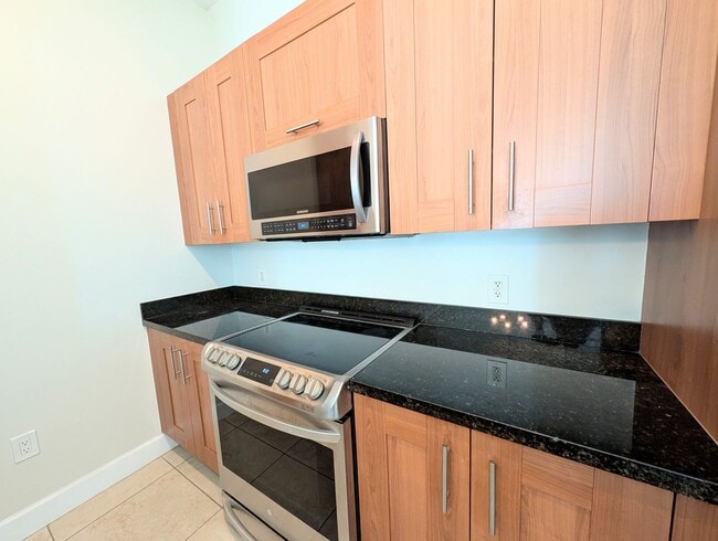 Building Photo - Modern 1BR/1BA Condo with 2 Parking Spaces – Prime Coral Gables Location