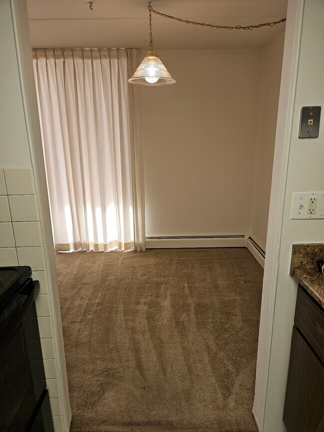Step into a cozy dining space perfect for intimate gatherings. - Lake Club Apartments
