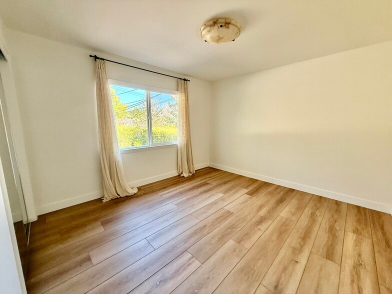 Bedroom 1 with layered window coverings - 496 Sherwood Way