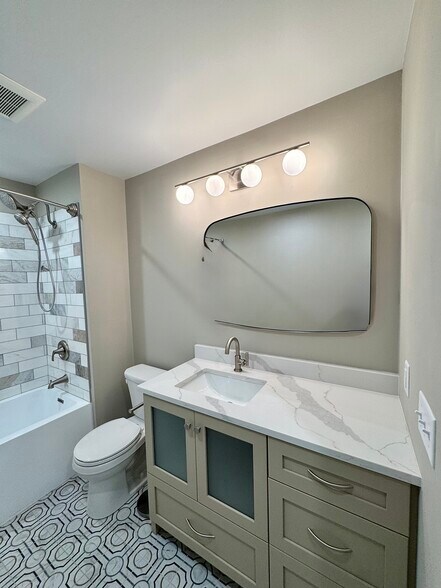 Large vanity with quartz countertop and custom cabinet. - 136 E King St