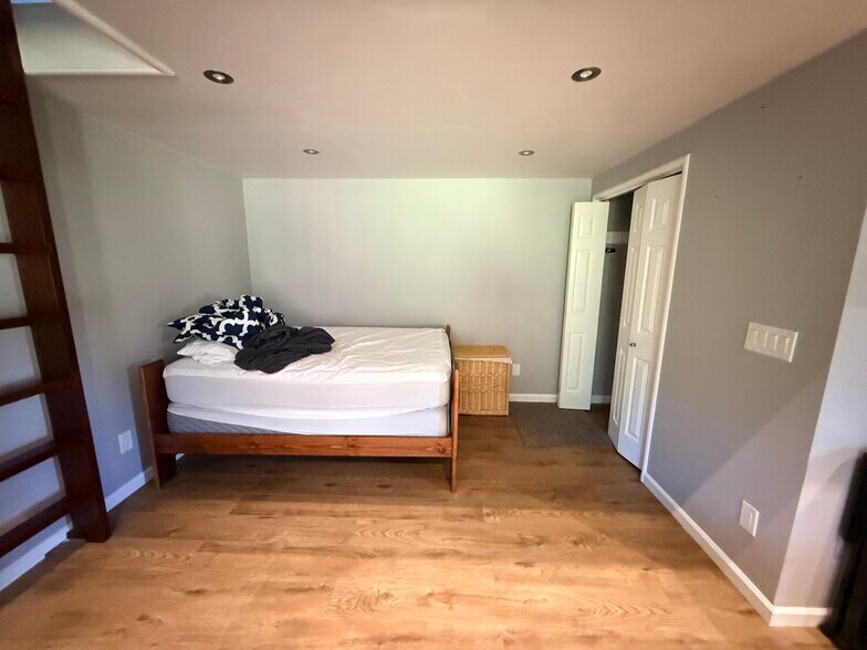 Studio bedroom with bed and bedding plus closet - 149 Cherry Ln