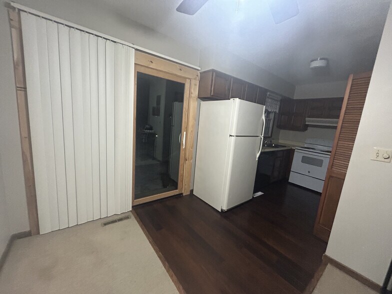 Sliding outdoor patio (wood is now finished), looking into kitchen. - 5672 Summer St
