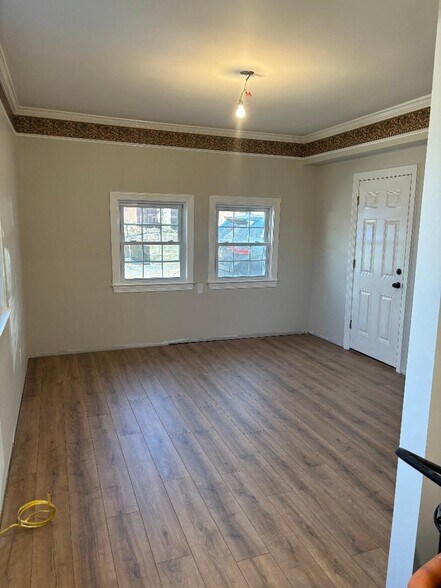 new floor & base trim being installed - 2721 Omisol Rd