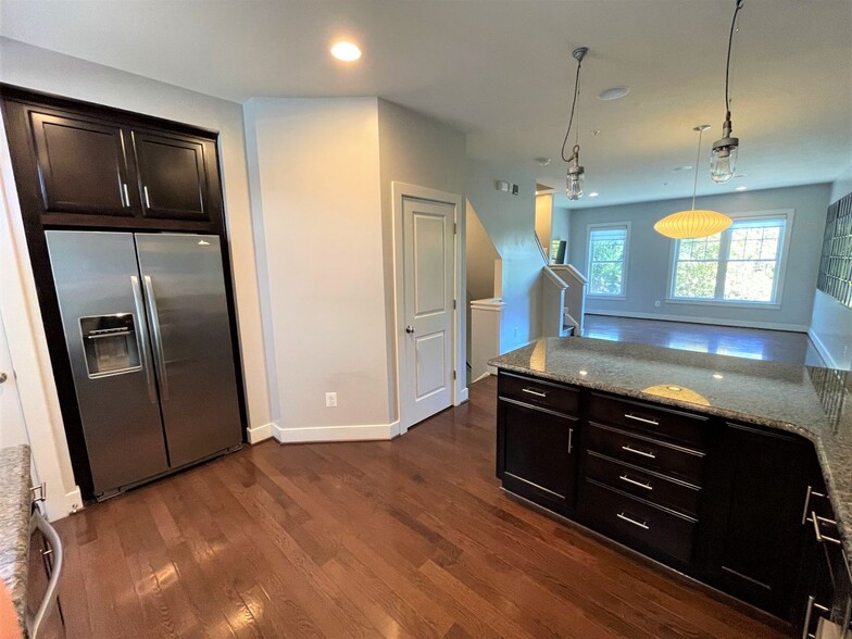 Kitchen view across the floor plan with half bath - 624 Regent Pl NE