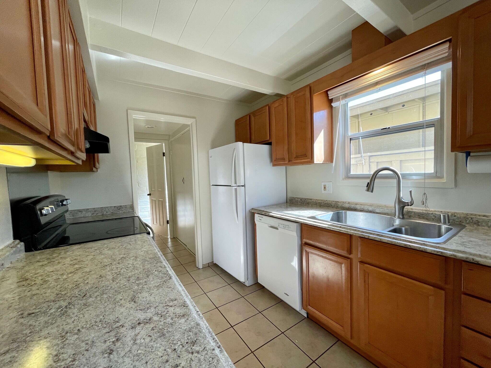 Kitchen looking toward laundry area and half bath. - 451 Dela Vina Ave