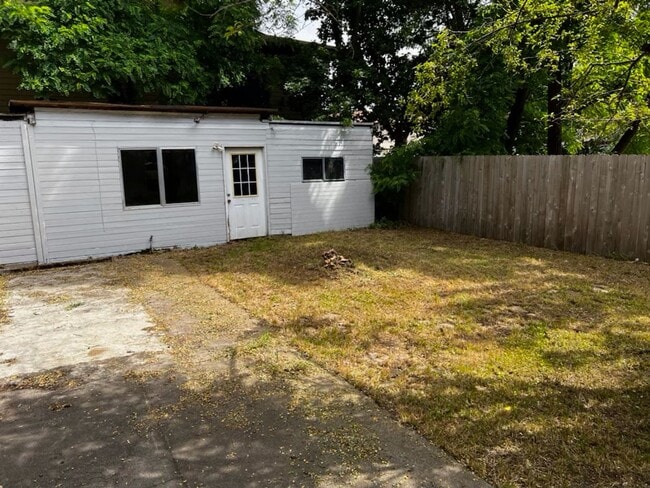 Building Photo - This 3-bedroom 1-bathroom house has a large front yard and a mostly fenced backyard.