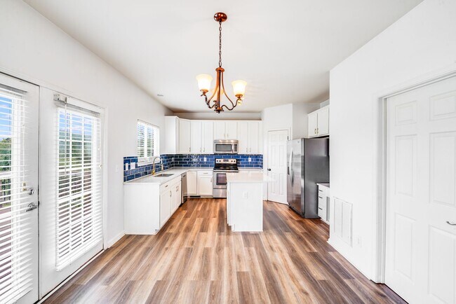 Building Photo - Enjoy Riverfront Living! Spacious 4-Bedroo...
