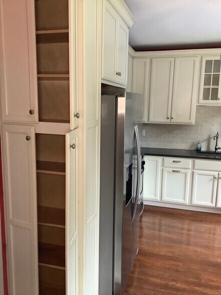 The pantry cabinets beside the refrigerator are 2' wide by 1' deep. - 9 Jay St