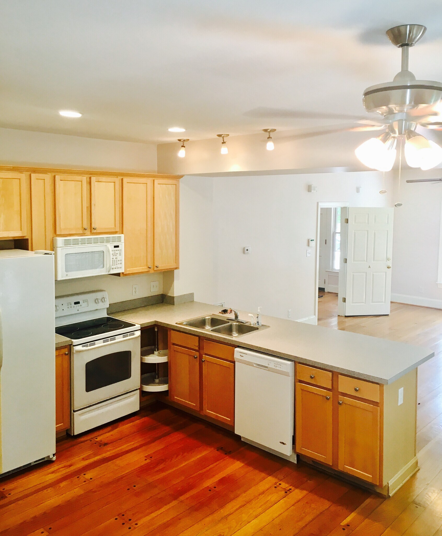 Kitchen with modern appliances, natural light, and open flow to dining and living. - 1937 Fairfield Dr