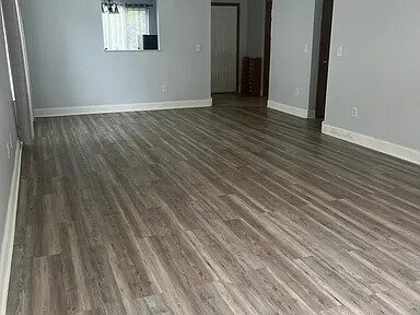 Building Photo - The home features beautiful LVP flooring, granite countertops, stainless steel appliances, and a ...
