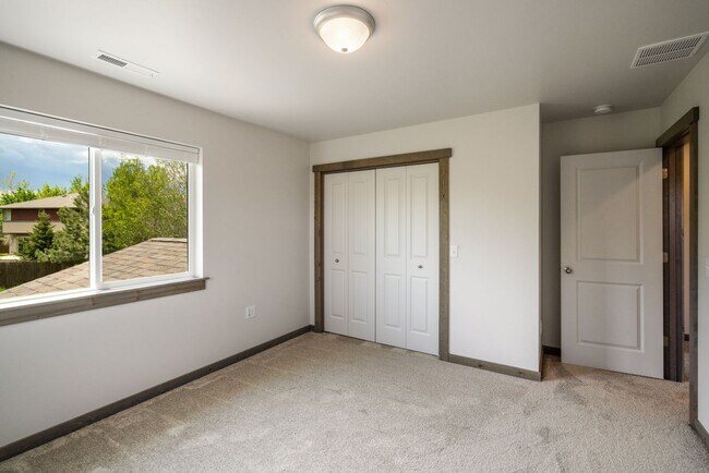 Building Photo - Pet Friendly! Gorgeous 3 Bedroom condo with double stall attached garages with AC.