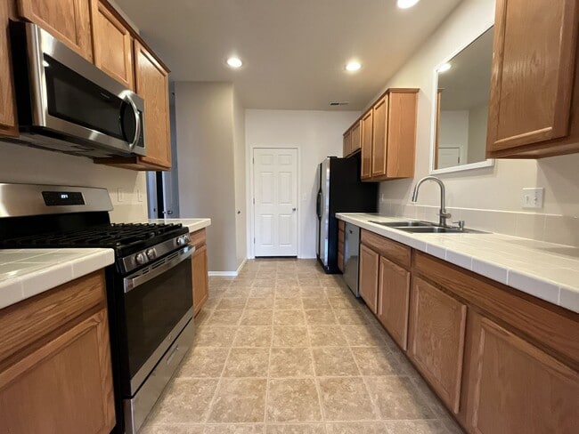 Building Photo - Inviting Two-Story 3BR Home Featuring Gas Range, Walk-In Closet, and Built-In Deck Seating