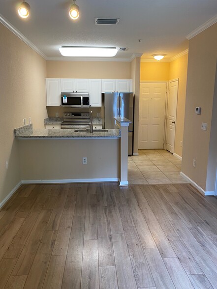 Living room to kitchen/entry - 9314 Crescent Loop Cir