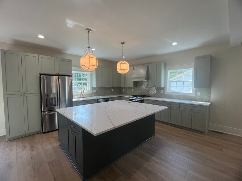 Gorgeous open kitchen with quartz countertops and an oversized island - 1250 S Madison Ave