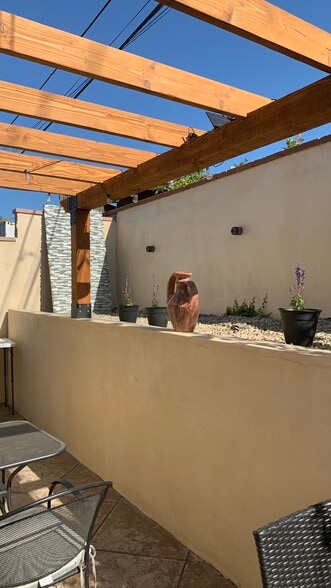 Private seating space, table, and pergola - 3087 Channel Dr