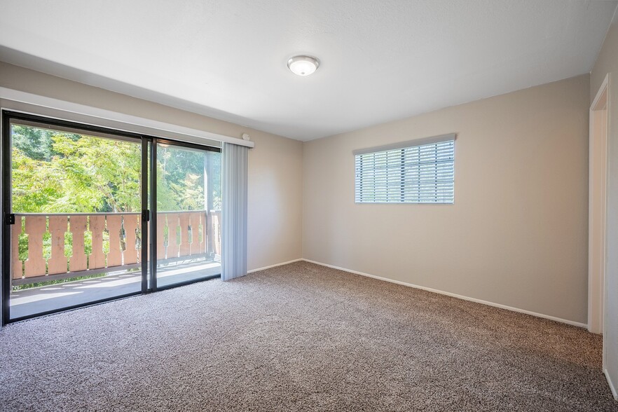 living room with sling glass door - Oak Park Apartments