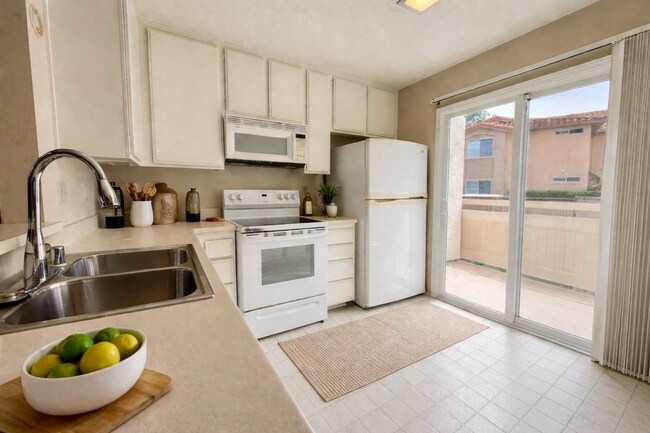 Building Photo - Move in Ready! 2BD Townhome! New Carpet! Two Patio Spaces! Attached Garage!