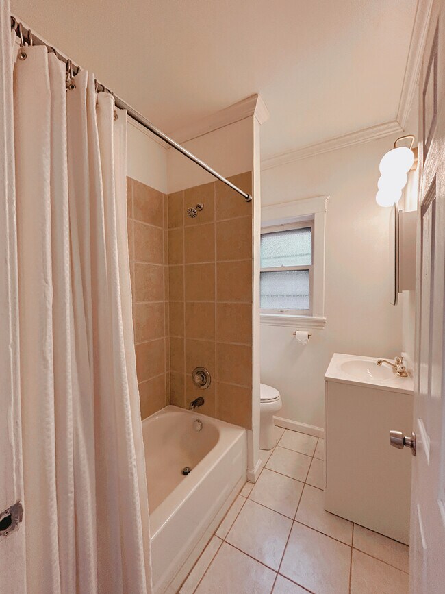 Bright, freshly renovated bathroom with shower/tub combination - 2705 S Kingshighway Blvd