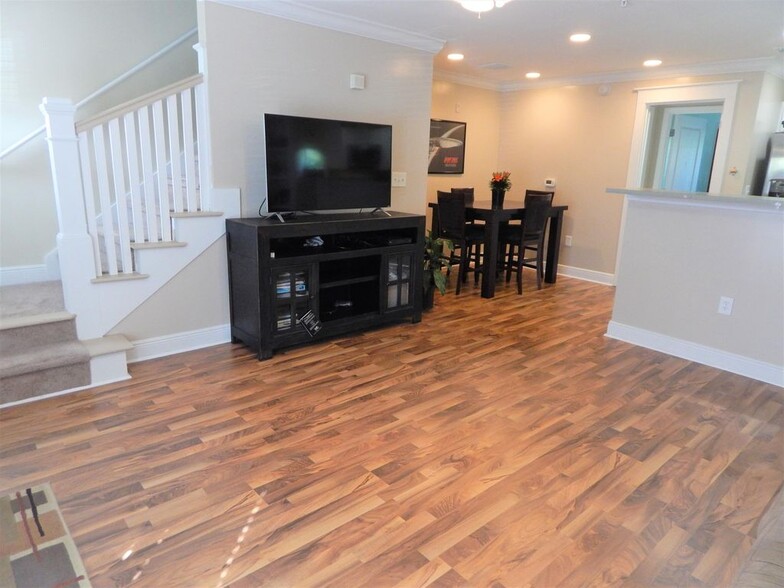 Open floor plan with bar counter separating living room from kitchen (furniture not included). Table and chars included. - 1105 Tree Top Way