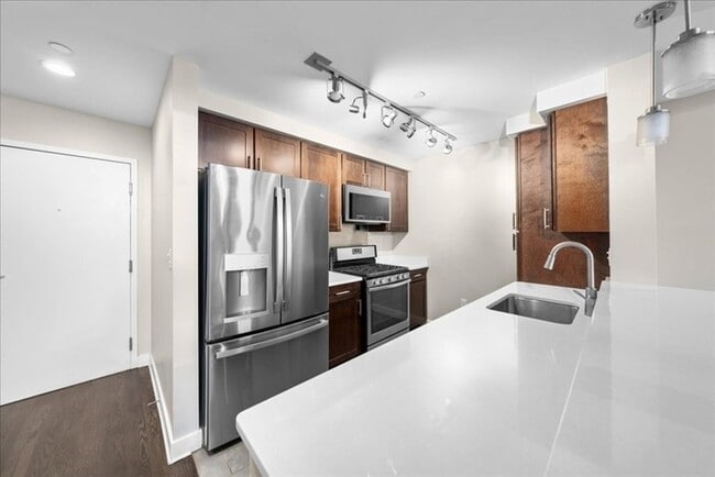 Building Photo - Stylish Industrial Loft with Exposed Brick, High Ceilings & Modern Kitchen