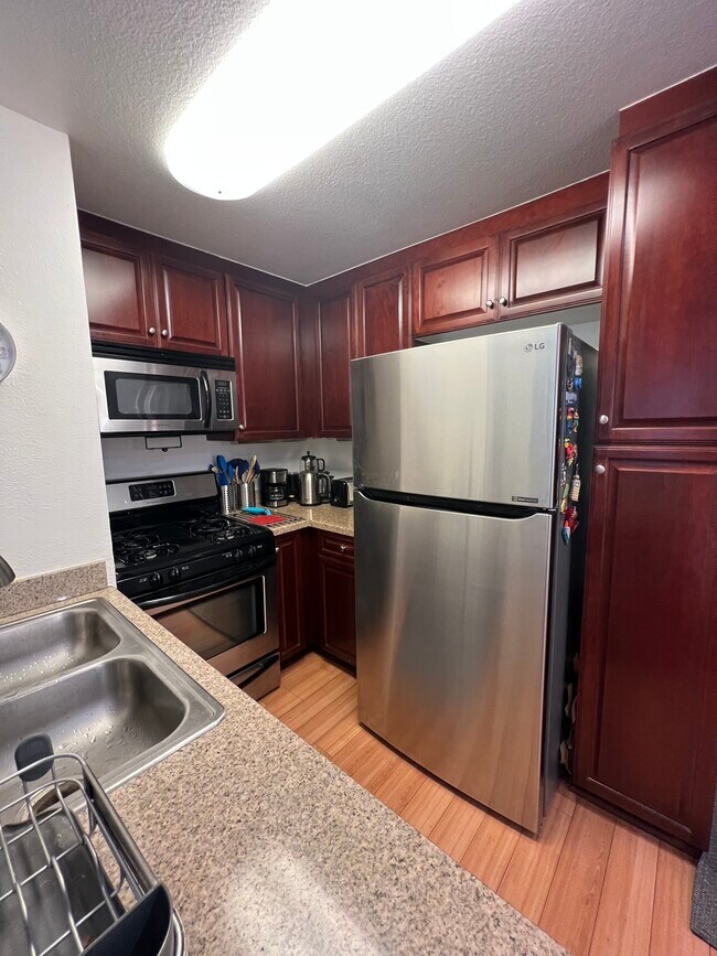 Kitchen with stainless steel appliances - 5520 Owensmouth Ave