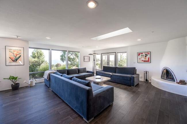 Living room with RH merino velvet sectional sofa and fireplace - 7401 Studio Rd