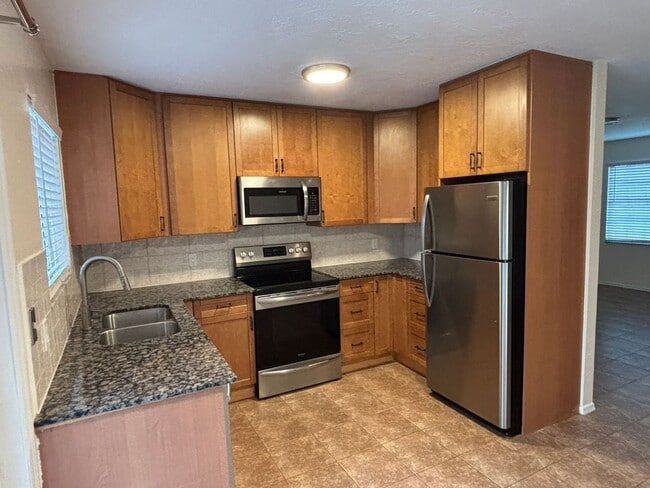 Building Photo - 2/2/1 home with a spacious fenced backyard...