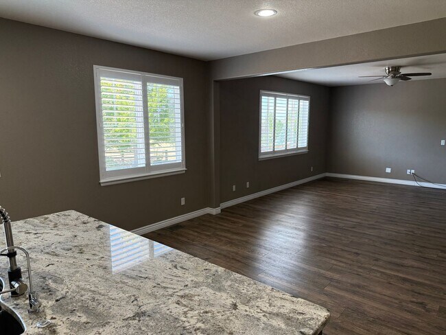 Building Photo - Greenbelt-Backed Wheatlands Home - Mountain Views, 3 Car Garage & Finished Basement