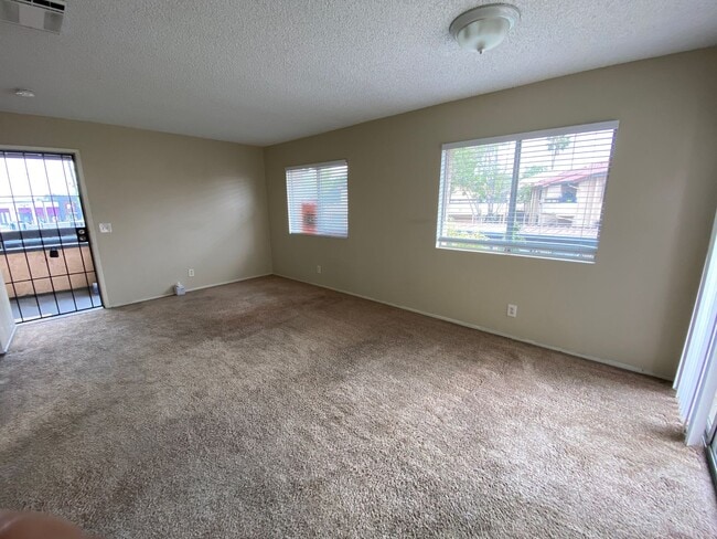 Building Photo - 2 BR 2 BA Corner Condo w/Balcony W/D Gated Entry Carport + Space