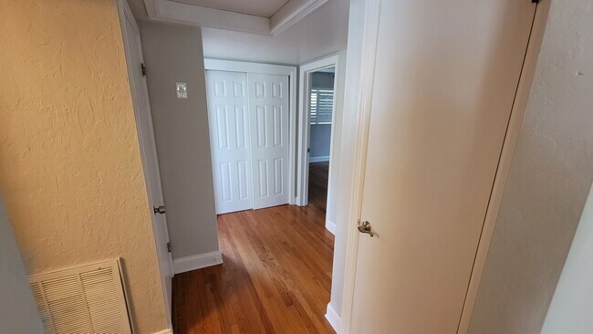 Hall from dining room entrance, with linen closet and hall closet. - 4359 4th Ave. S.