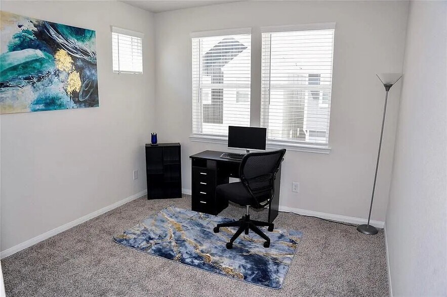 Previously an office, this room now has bedroom furniture - 9829 Heritage Run Ln